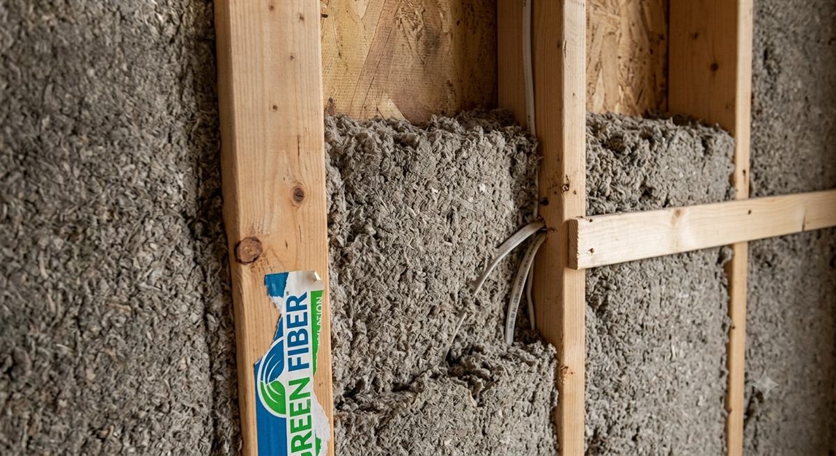 Green Fiber cellulose insulation packed into an open wall cavity