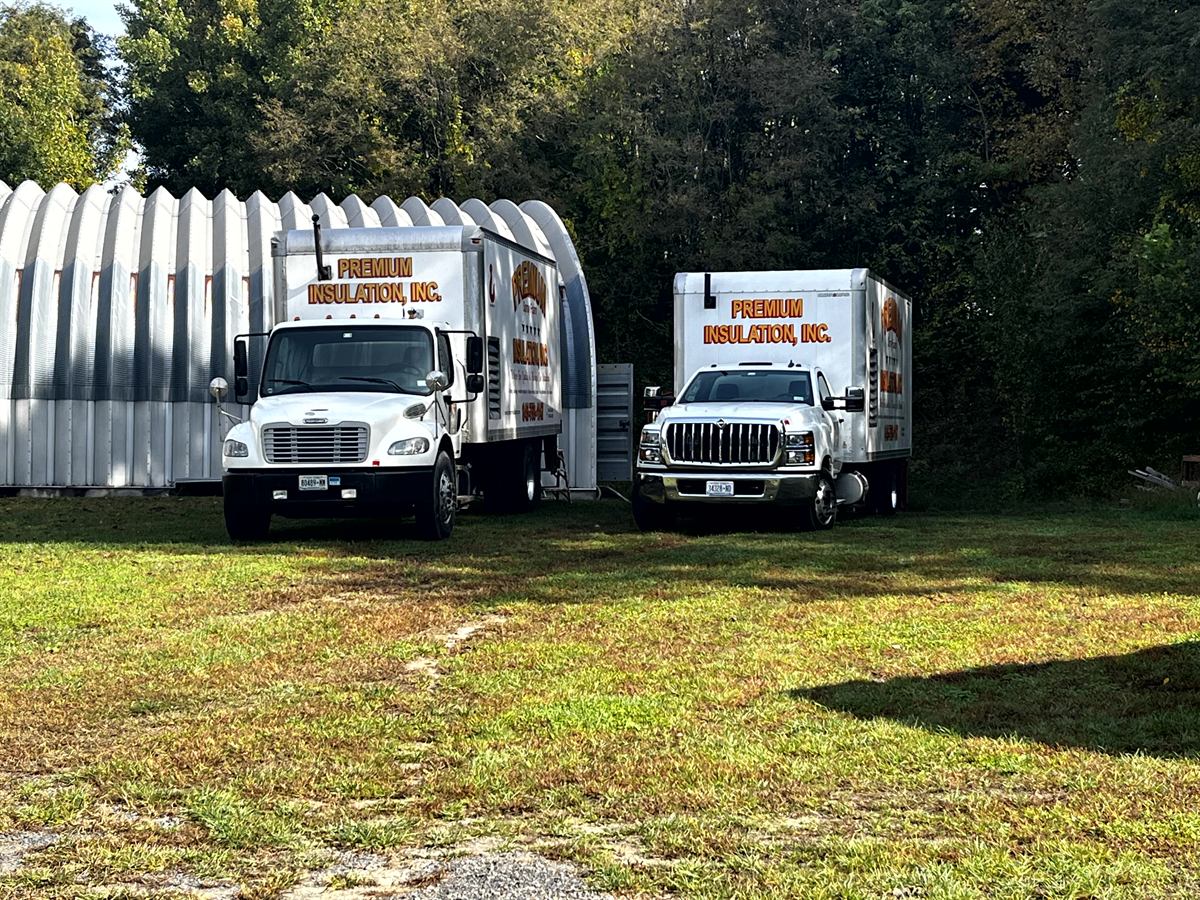 Premium Insulation fleet trucks parked at Red Hook, NY airfield hangar